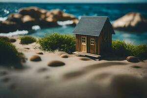un miniatura casa en el playa con rocas y césped. generado por ai foto