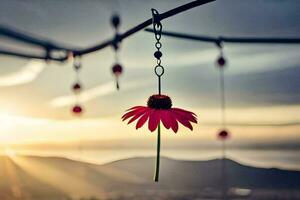 a red flower hangs from a wire with a sunset in the background. AI-Generated photo