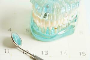 Dental appointment reminder in calendar, healthy teeth, dental health care. photo