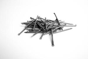 Pile Of Silver Shiny Sharp Metal Nails Scattered On White Background Closeup Photo