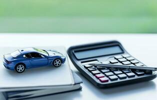 Car loan,money, banknote on agreement document or car insurance application form. Saving money for car concept, trade car for cash concept, finance concept. photo