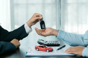 Closeup asian women people car saler or sales manager offers to sell a car and explains and reads the terms of signing a car contract and insurance. photo