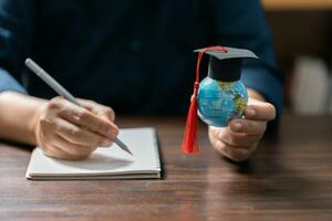 Graduation cap with Earth globe. Concept of global business study, abroad educational, Back to School. Education in Global world, Study abroad business in universities in worldwide. language study photo