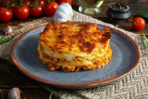 Classic lasagna with minced chiken bolognese sauce and bechamel sauce photo