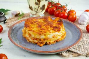 Classic lasagna with minced chiken bolognese sauce and bechamel sauce photo