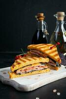 Club sandwich with ham, tomato and cheese. Grilled sandwich photo