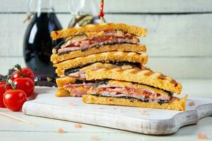 Club sandwich with ham, tomato and cheese. Grilled sandwich photo