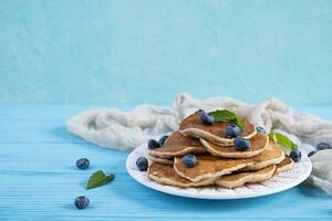 Pancakes with honey and blueberries. Sweet homemade pancakes photo