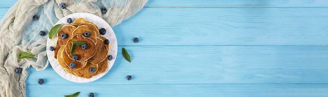 Pancakes with honey and blueberries. Sweet homemade pancakes photo