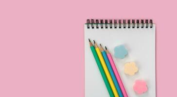 Flatlay composition with school stationery on a pink background. Back to school. Copy space. Top view. photo