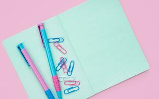 Colorful stationery on a pink background with space for text. Flatlay. Back to school. Top view. photo