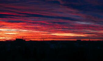 Evening red-orange sky over the city. Sunset. Selective focus. Noise. photo