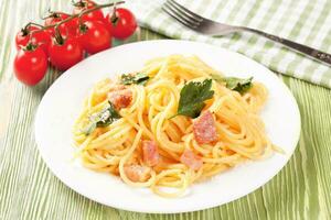 Pasta Carbonara served on a white plate. photo