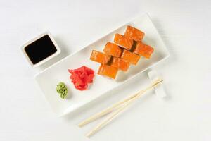 Sushi roll Philadelphia with salmon, smoked eel, avocado, cream cheese on white background photo