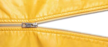 Yellow leather texture and open metal zipper isolated on white background photo