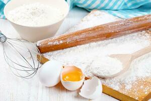 Baking ingredients on white wooden background photo