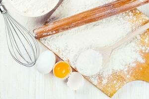 Baking ingredients on white wooden background photo