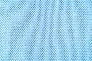 Bright blue knitwear wool fabric texture background. Abstract textile backdrop photo