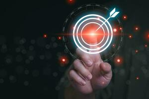 planning and strategy progress or success The man's hand is touching the target he has set. Display as a virtual hologram, online trading, information search, and online marketing photo