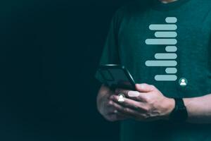 The concept of using digital media, technology, and social media. Surfing online, male hand using smartphone To play or use social media, remote work concept, work from home via the Internet photo