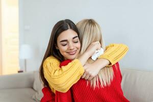 Candid diverse girls best friends embracing standing indoors, close up satisfied women face enjoy tender moment missed glad to see each other after long separation, friendship warm relations concept photo