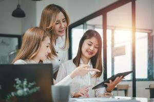 Female operations manager holds meeting presentation for a team of economists. Asian woman uses business paper with Growth Analysis, Charts, Statistics and Data. photo