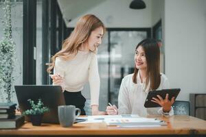 Female operations manager holds meeting presentation for a team of economists. Asian woman uses business paper with Growth Analysis, Charts, Statistics and Data. photo