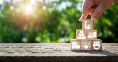 Logistics concept, Person hand holding wooden block with logistics icon on virtual screen. photo