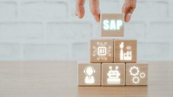 SAP - Business process automation software and management software, Wooden block with VR screen SAP icon on office desk, Business, modern technology, internet and networking concept photo