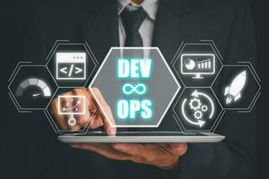 DevOps concept, Businessman using tablet with DevOps icon on virtual screen, Methodology development operations agil programming technology.concept. photo