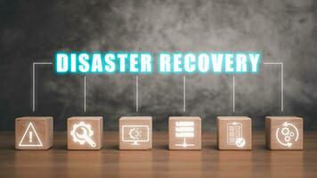 Disaster Recovery concept, Wooden block on desk with disaster recovery icon on virtual screen background, Data loss prevention. photo