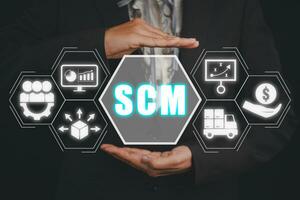 SCM, Supply Chain Management concept, Business person hand holding Supply Chain Managemen icon on virtual screen background, plan, distribution, procurement, and profit photo