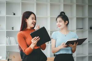 Business woman talking to her colleague during a meeting in a boardroom, Business team working on digital tablet. photo