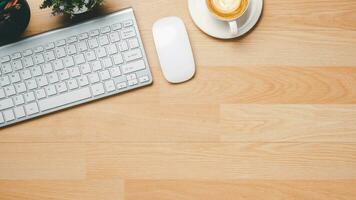 Office desk with keyboard, mouse, pen and cup of coffee, Top view wth copy space, Flat lay. photo