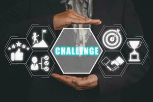Challenge concept, Business woman hand holding challenge icon on virtual screen. photo