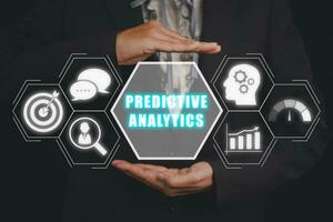 Predictive analytics concept, Business woman hand holding predictive analytics icon on virtual screen. photo