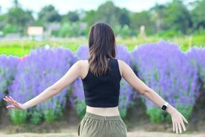 back of a beautiful tourist admiring the flower garden in Chiang Mai blessed because the flower garden looks beautiful. woman is blessed a walk in the beautiful flower garden and the bright nature. photo