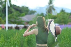 back of a beautiful tourist admiring the flower garden in Chiang Mai blessed because the flower garden looks beautiful. woman is blessed a walk in the beautiful flower garden and the bright nature. photo