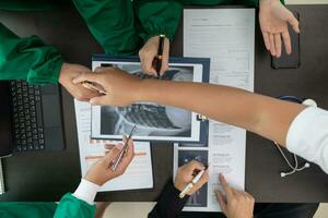 The doctor joins a meeting with the surgeon's team to discuss a plan for cancer surgery after the medical team detects cancer. Collaborative concept of a team doctors and surgeons in surgery. photo