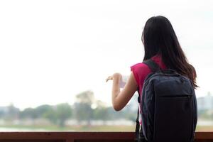 Back scene of woman alone with feeling lonely and depressed on blurred background of beautiful nature scenery . concept of woman who had to be alone in past was depressed when she encountered problems photo