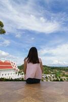 Back scene of woman alone with feeling lonely and depressed on blurred background of beautiful nature scenery . concept of woman who had to be alone in past was depressed when she encountered problems photo