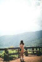 Back scene of woman alone with feeling lonely and depressed on blurred background of beautiful nature scenery . concept of woman who had to be alone in past was depressed when she encountered problems photo
