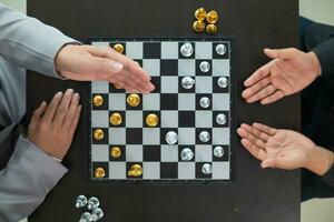 Young businessman planning winning chess move in game of chess representing successful and victorious business path. chess concept representing strategic business strategy to achieve victory. photo