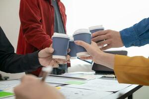 Programmers and UI ux designers have cup of hot coffee together in design studio during breaks for brain boosting coffee boost before starting another round.  design team coffee break concept photo