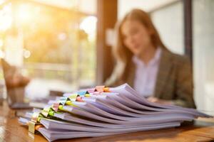 stack of documents on secretary desk were prepared It is legal document for real estate buyers to be used as evidence of possession. stacked papers were placed on the table awaiting examination. photo