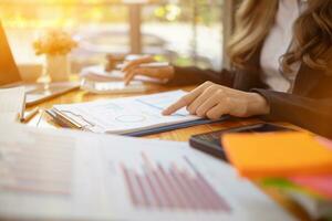 An accountant is using a calculator to accurately calculate the income and expenses and is using the calculator to review the company investment results and profits Copy Space for text photo
