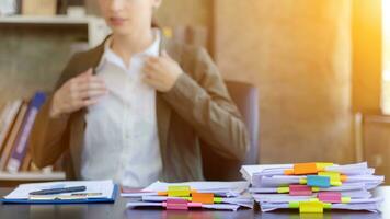 Businesswoman hands working on stacks of paper documents to search and review documents piled on table before sending them to board of directors to use  correct documents in meeting with Businessman photo