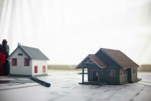 Construction engineers place plans and model homes  on desks in their offices for real estate agents to view the plans they want construction engineers to build on budget and meet client needs. photo