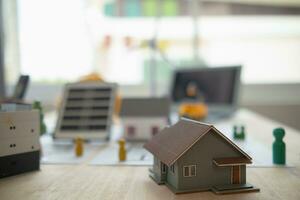 Construction engineers place plans and model homes  on desks in their offices for real estate agents to view the plans they want construction engineers to build on budget and meet client needs. photo