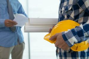 Construction engineers discuss and exchange ideas with architects to improve house plans to meet customer needs. A concept for exchange of design ideas between construction engineers and architects. photo